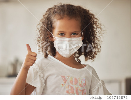 Girl with a covid face mask and thumbs up like sign showing she is wearing protection or caution against virus, One brave and responsible little child with good OK gesture or success emoji expression Girl with a covid face mask and thumbs up like sign showing she is wearing protection or caution against virus, One brave and responsible little child with good OK gesture or success emoji expression 105712872