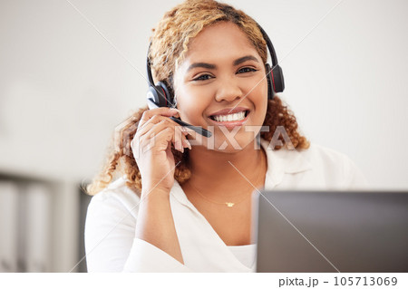 Happy, smiling and friendly call center agent wearing headset while working in an office. Portrait of confident businesswoman consulting and operating helpdesk for customer sales and service support 105713069