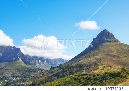 View of mountains with a path and cityscape against blue sky copyspace. A peaceful mountain with a scenic background in quiet Lions Head in Cape Town, South Africa. Nature backdrop with a hill top 105713384
