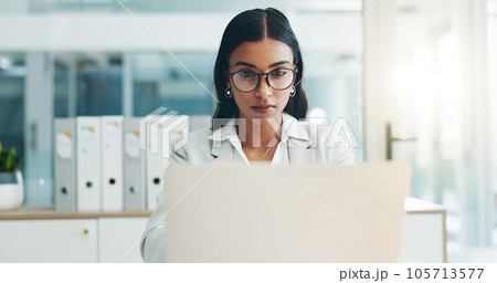 Business woman, glasses and working on laptop in office for planning, reading email and internet research in law firm. Indian lawyer, attorney and focus at computer to start legal analysis in company Business woman, glasses and working on laptop in office for planning, reading email and internet research in law firm. Indian lawyer, attorney and focus at computer to start legal analysis in company 105713577