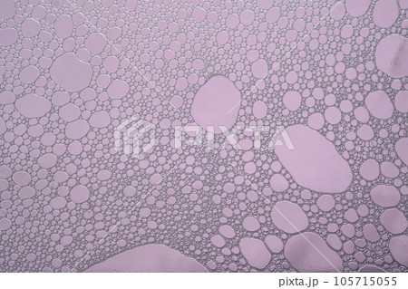 Fluffy white foam on a purple background. Fluffy white foam on a purple background. 105715055