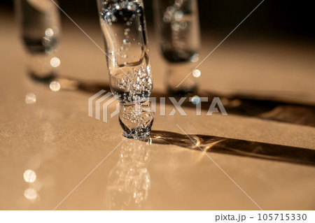 Three pipettes of cosmetic gel on a beige background. Three pipettes of cosmetic gel on a beige background. 105715330