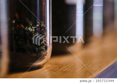 Glass containers with tea brews. Abstract background. 105715344