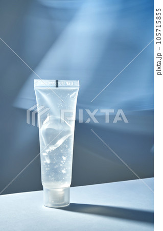 Transparent bottle of cosmetic gel on a blue background. Transparent bottle of cosmetic gel on a blue background. 105715855