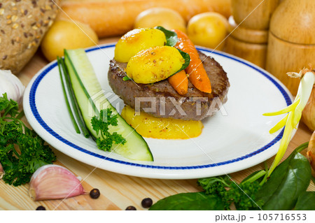 Beef cutlet with baked new potatoes and carrots 105716553