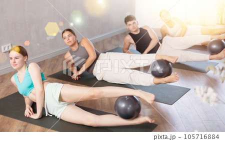 Young people doing softball pilates in studio. - Stock Photo [105716759] -  PIXTA