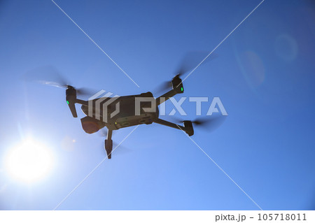 Flying drone in high altitude mountains 105718011