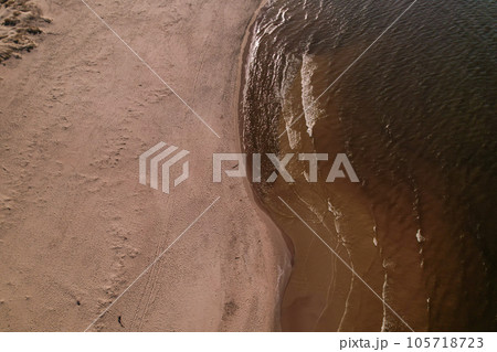 Drone aerial view of waves sea ocean coast. Beach and dunes dark calm sea waves nature landscape captured with drone. Tourism Drone aerial view of waves sea ocean coast. Beach and dunes dark calm sea waves nature landscape captured with drone. Tourism 105718723