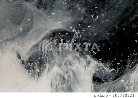 Abstract paint splash isolated on black background. Acrylic ink in water. selective focus. 105720321