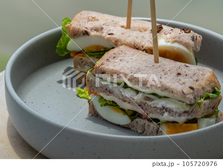 Homemade sandwich's stuffed with chicken breast, cheese, boiled eggs and fresh vegetables. Homemade sandwich's stuffed with chicken breast, cheese, boiled eggs and fresh vegetables. 105720976