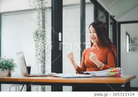 Businesswoman happy and cheerful for successful on project via laptop in office space. 105721514