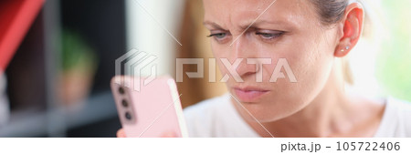 Unhappy woman reading messages in her smartphone, bad news concept. 105722406