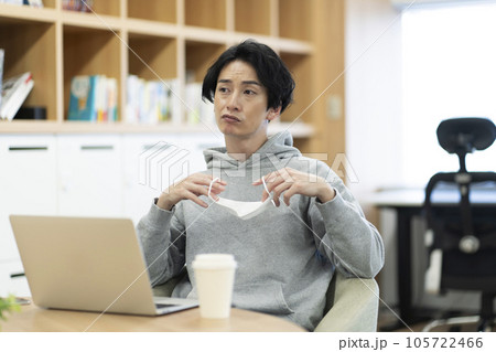 マスクを外す若い男性 105722466