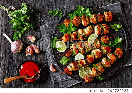 chicken souvlaki with parsley and lime on plate 105723321