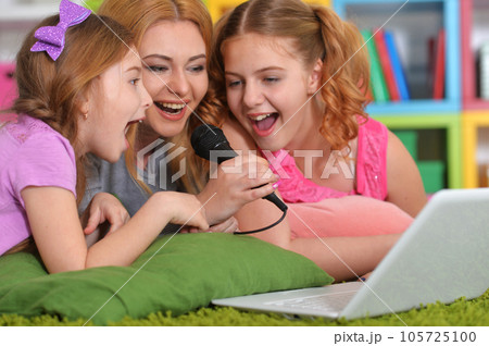 woman and girls using laptop woman and girls using laptop 105725100