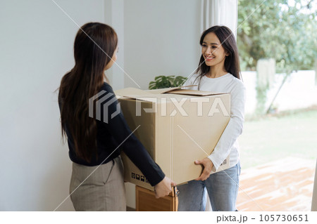 Young woman couple smiling happy and moving box together at new home. Homosexual-LGBTQ concept 105730651
