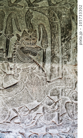 Wall carving of Khmer Culture in Ancient ruins Angkor Wat temple - famous Cambodian landmark. Siem Reap, Cambodia. Wall carving of Khmer Culture in Ancient ruins Angkor Wat temple - famous Cambodian landmark. Siem Reap, Cambodia. 105733302