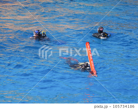 Divers with signal buoy on the surface of the sea, after the dive. Diving on the Red sea.	 105734186