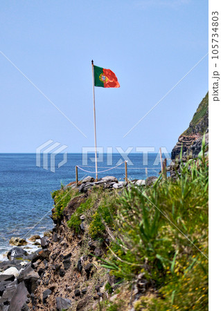 Waving Portugal flag on the edge of rocky cliff. Azores 105734803