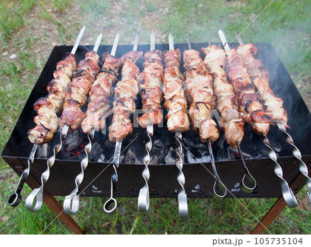 Shashlik on skewers is prepared on the grill over the coals. 105735104