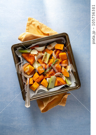 Pumpkin soup. Butternut squash and vegetables ready to be baked in baking tray. Pumpkin soup. Butternut squash and vegetables ready to be baked in baking tray. 105736381