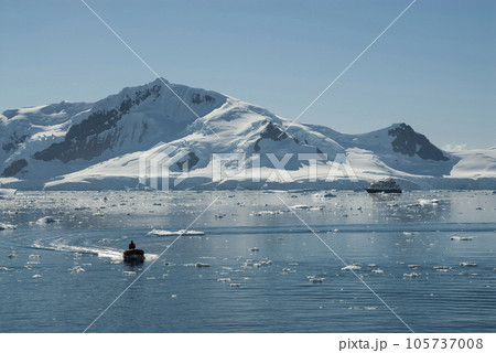 Tourists observing a glacier on the Antarctica, Paradise bay, Antartic Peninsula. 105737008