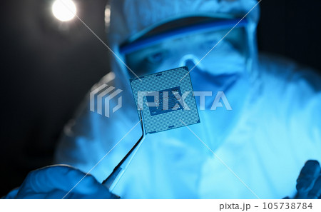 Male hand in blue protective gloves with tweezers hold micro rocessor Male hand in blue protective gloves with tweezers hold micro rocessor 105738784
