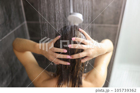 Woman takes shower in the bathroom closeup Woman takes shower in the bathroom closeup 105739362