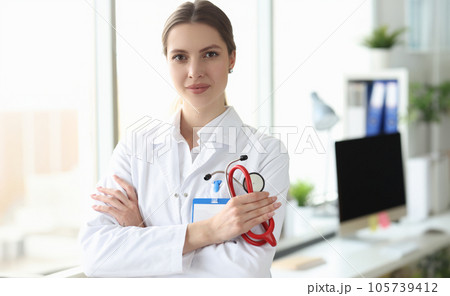 Portrait of smiling female doctor in white coat in medical office 105739412