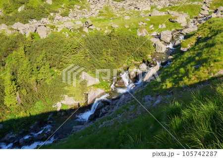 countryside scenery with river. trees and stones along the shore down the hill. view from above 105742287