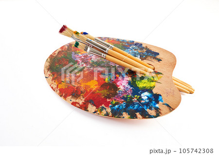 Wooden art palette with brushes isolated on white background. 105742308