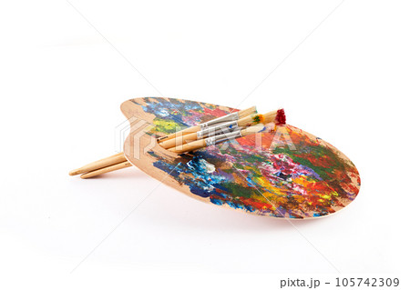 Wooden art palette with brushes isolated on white background. 105742309