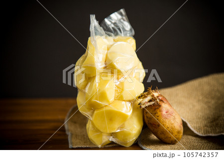peeled potatoes closed in a vacuum bag and old sprouted potatoes peeled potatoes closed in a vacuum bag and old sprouted potatoes 105742357