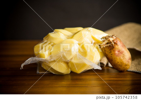 peeled potatoes closed in a vacuum bag and old sprouted potatoes peeled potatoes closed in a vacuum bag and old sprouted potatoes 105742358