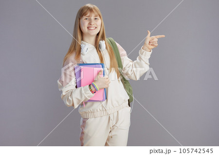 Portrait of happy trendy teenage girl in beige tracksuit Portrait of happy trendy teenage girl in beige tracksuit 105742545