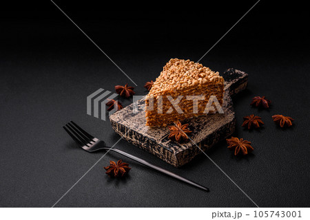 Delicious sweet puff waffle cake with cream and nuts cut into pieces Delicious sweet puff waffle cake with cream and nuts cut into pieces 105743001