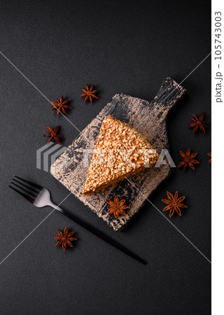 Delicious sweet puff waffle cake with cream and nuts cut into pieces Delicious sweet puff waffle cake with cream and nuts cut into pieces 105743003