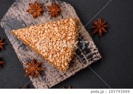Delicious sweet puff waffle cake with cream and nuts cut into pieces Delicious sweet puff waffle cake with cream and nuts cut into pieces 105743009