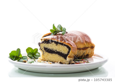 roll with poppy seeds inside on a white background 105743385