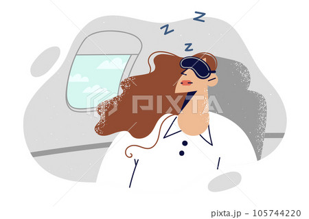 Woman passenger on airplane sleeps with mask over eyes, going on business trip.  105744220