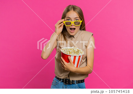 Woman in 3D glasses eating popcorn and watching interesting tv serial, sport game film, online movie Woman in 3D glasses eating popcorn and watching interesting tv serial, sport game film, online movie 105745418