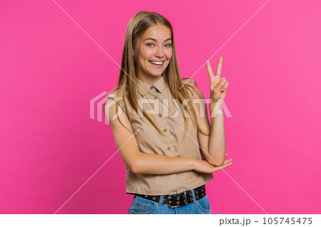 Woman girl showing victory V sign, hoping for success and win, doing peace gesture with two fingers Woman girl showing victory V sign, hoping for success and win, doing peace gesture with two fingers 105745475
