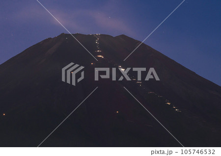 ご来光を見るために夜通しで富士山頂を目指す登山者たちの光跡 105746532