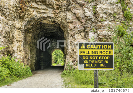 MKT tunnel on Katy Trail at Rocheport, Missouri with a falling rocks warning sign. 237 mile bike trail stretching across the state of Missouri is converted from an old railroad. 105746673
