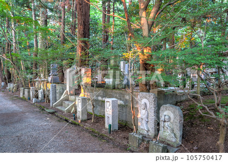 Stone memorials at Daijouji temple, at sunset, Kanazawa, Japan. Stone memorials at Daijouji temple, at sunset, Kanazawa, Japan. 105750417
