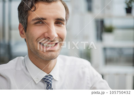 Confident young businessman posing in the office Confident young businessman posing in the office 105750432