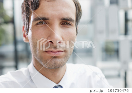 Portrait closeup of serious concentrated businessman wearing white shirt looking at camera, 105750476