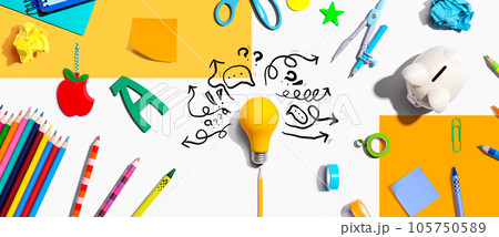 Brainstorming concept with a light bulb and school supplies 105750589