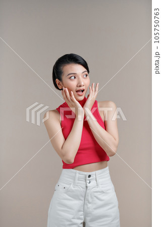 Young asian female amazed with happiness in positive shock cheering to good amazing news 105750763