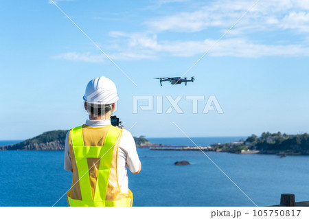 海辺でドローンを操縦する男性作業員|ドローンイメージ|点検イメージ 海辺でドローンを操縦する男性作業員|ドローンイメージ|点検イメージ 105750817